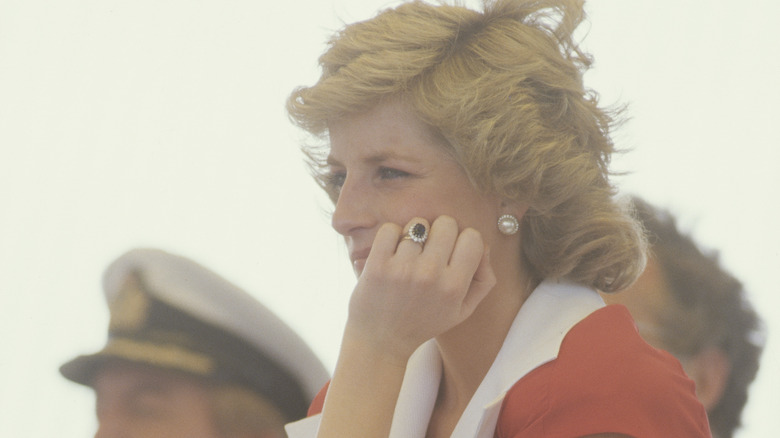 Princess Diana looking wistfully wearing ring