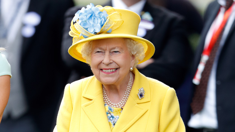 Queen Elizabeth smiling in yellow 