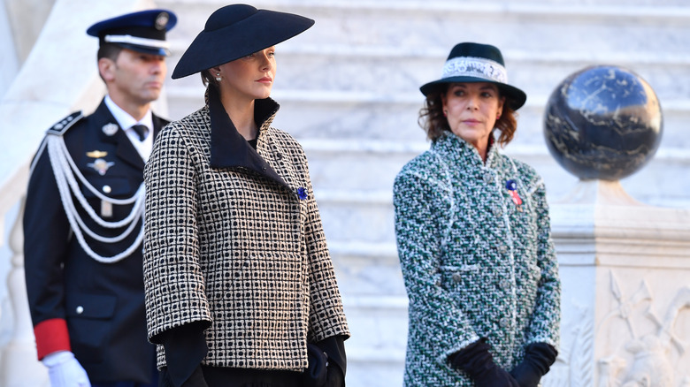 Princess Charlene wearing hat a coat outside