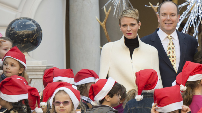 Princess Charlene & Prince Albert surrounded by children