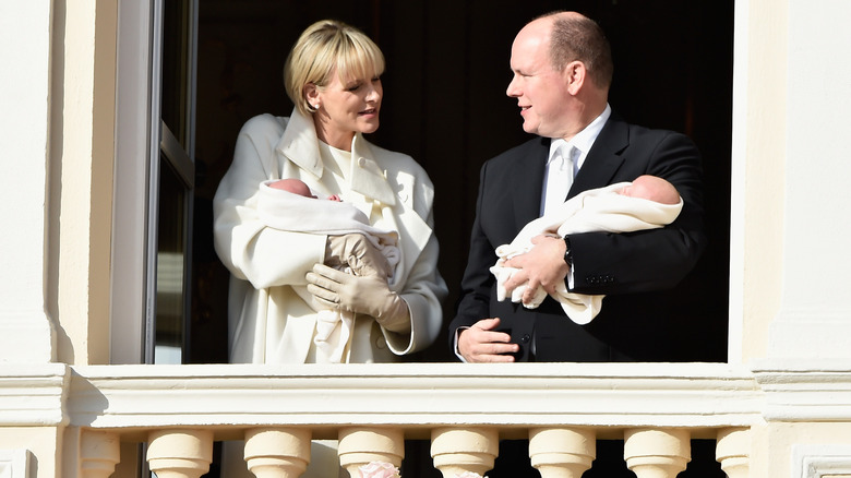 Princess Charlene and Prince Albert holding their babies