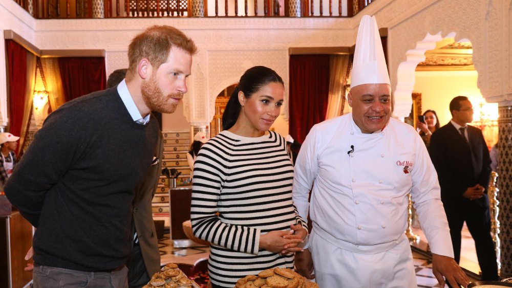 Prince Harry and Meghan Markle speak to a chef