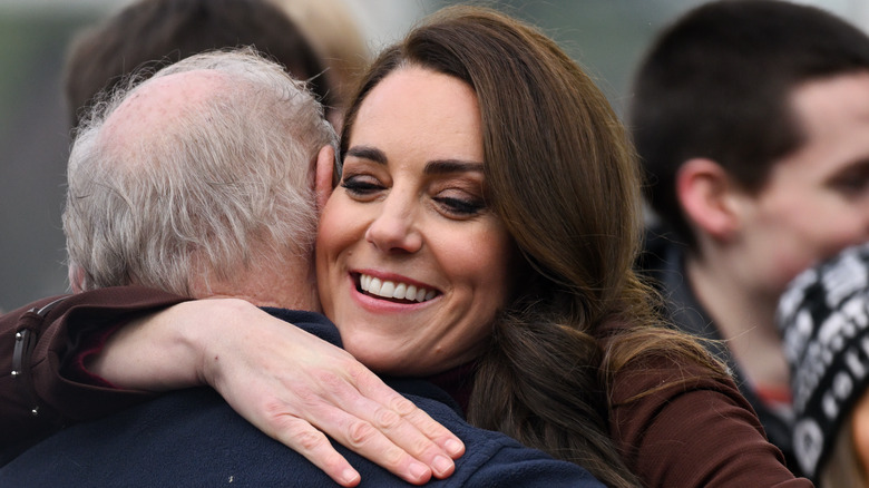 Kate hugs her former history teacher