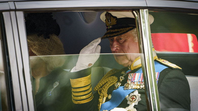 King Charles III in a car