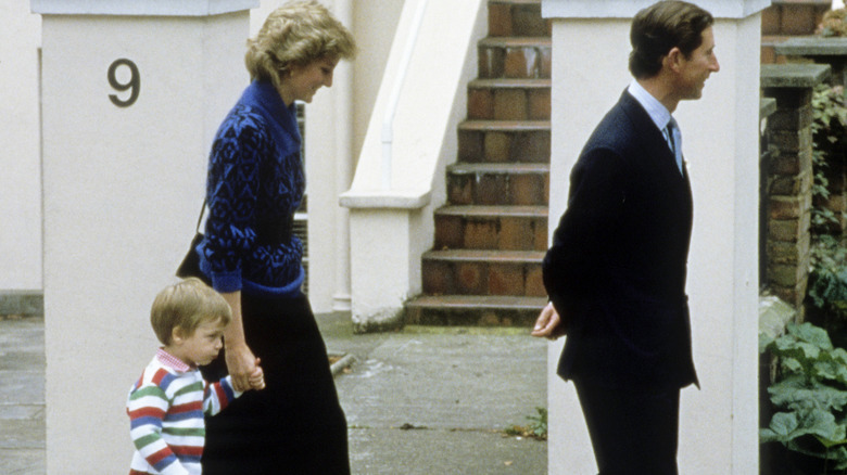 Charles and Diana walking with William