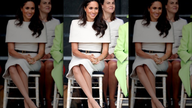 Meghan Markle with Samantha Cohen sitting behind her and the Queen