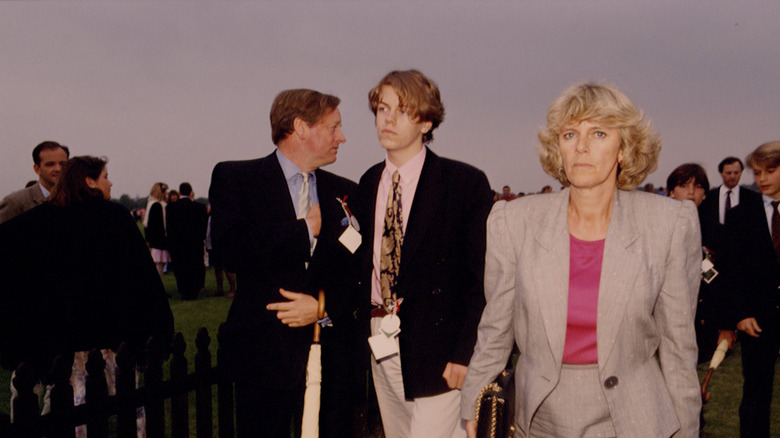 Camilla in gray suit, fuchsia blouse