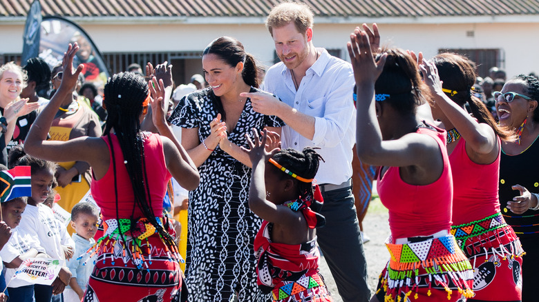 Prince Harry and Meghan Markle among dancing women