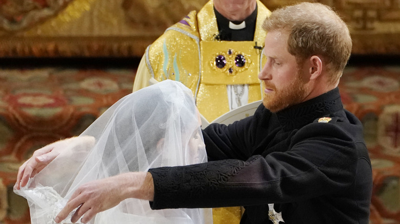 Prince Harry lifting Meghan Markle's veil