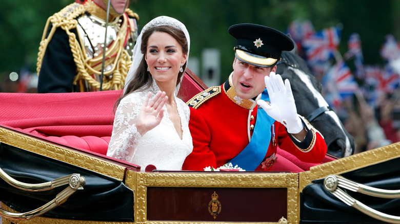 Prince William and Kate Middleton in a carriage waving on the their wedding day