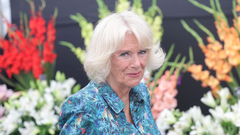 Camilla Parker Bowles posing with flowers