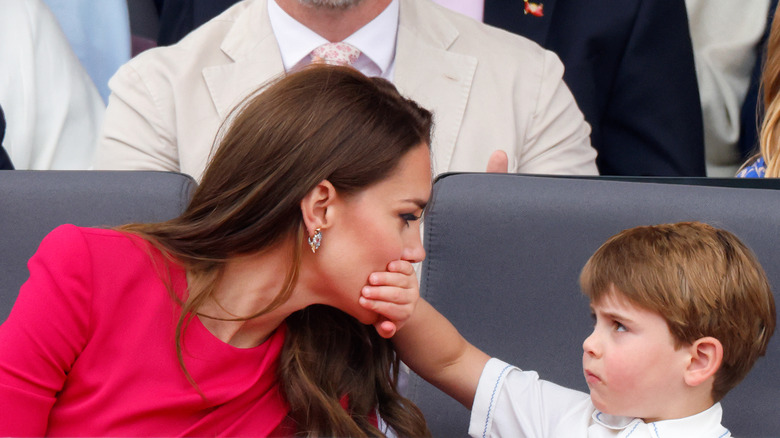 Prince Louis covering Kate Middleton's mouth in public