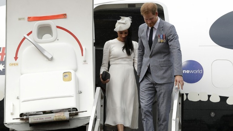 The Duke and Duchess of Sussex deboarding an airplane