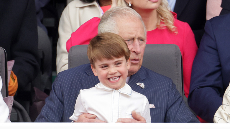 Prince Louis sitting on Charles lap 