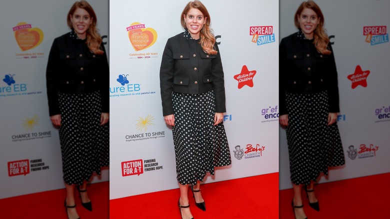 Princess Beatrice smiling on step-and-repeat