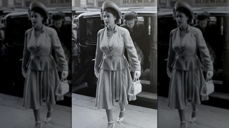 Young Queen Elizabeth II crossing a sidewalk after existing a car