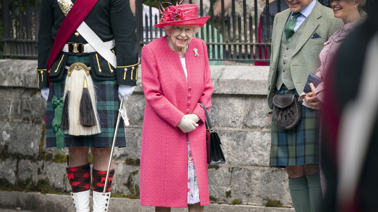 Close up of Queen Elizabeth II in pink hat 