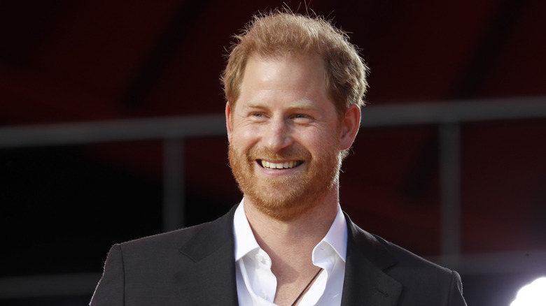 Prince Harry smiling in black suit