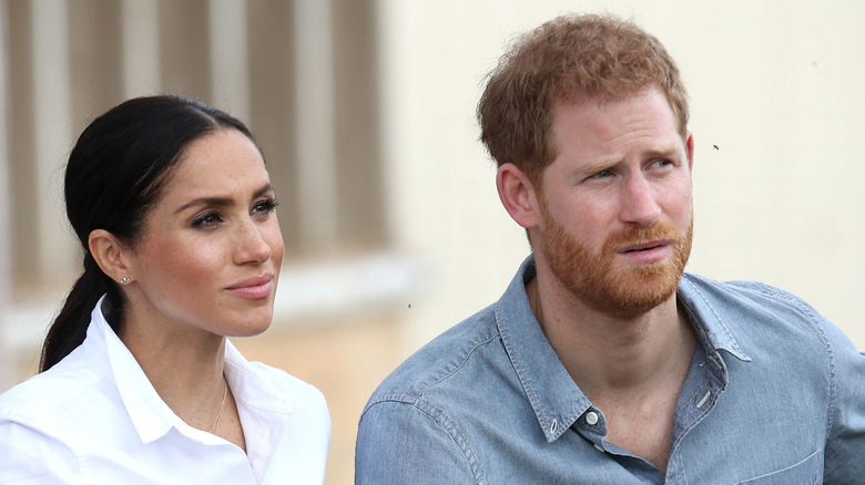 Prince Harry and Meghan Markle listening during an interview