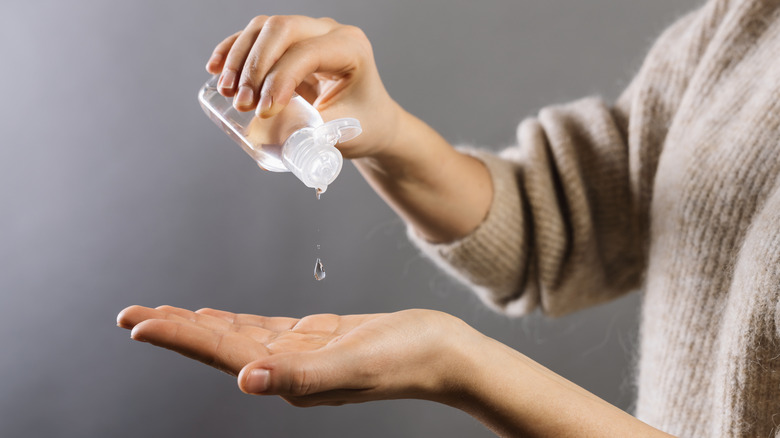 Hands applying sanitizer 