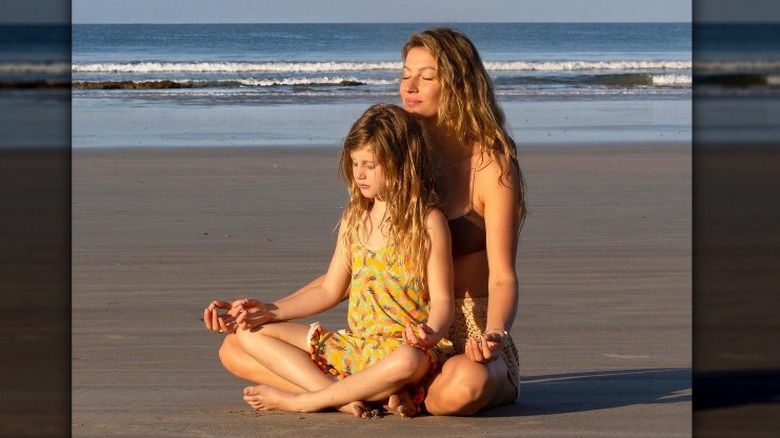 Gisele Bündchen and daughter meditating