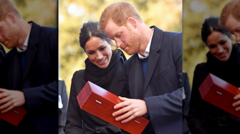 Meghan Markle Prince Harry receiving gift