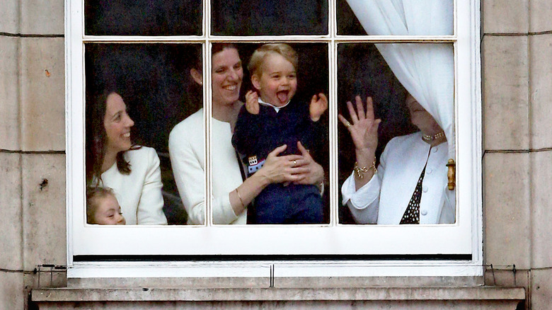 Maria Borallo holds Prince George at window