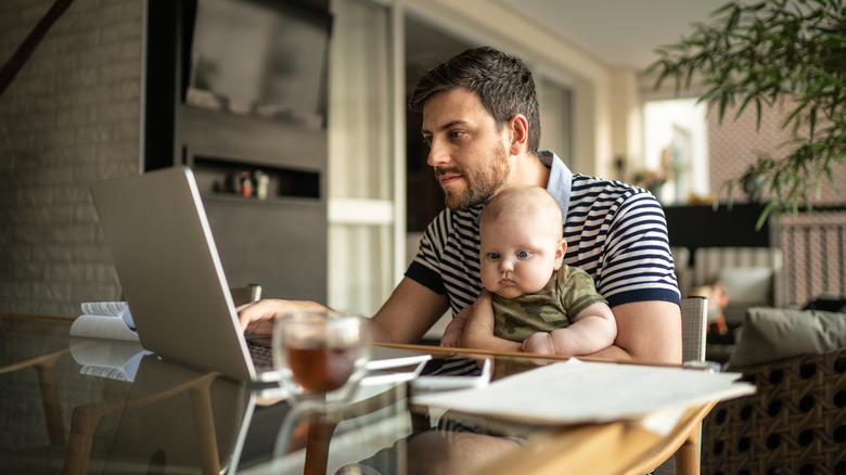 Man working with baby in lap