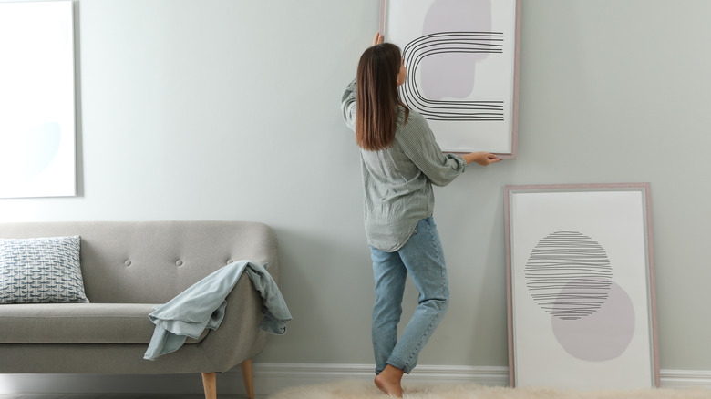 Woman hanging art