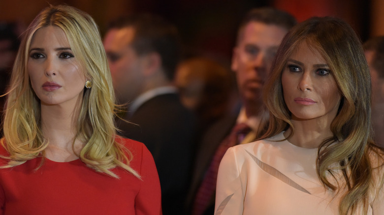 Ivanka and Melania Trump sit side by side with stern faces