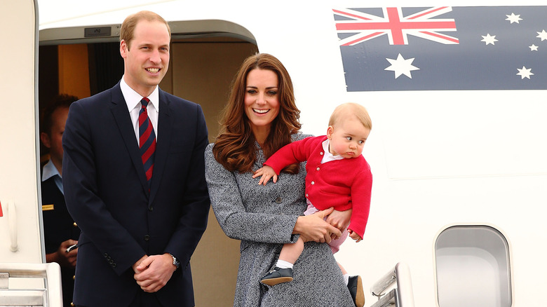 Prince William, Kate Middleton and baby Prince George in front of plane