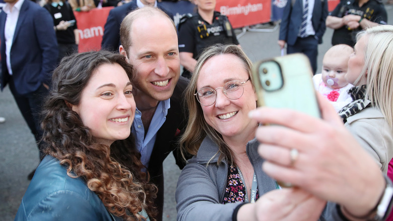 Prince William taking selfie with two fans