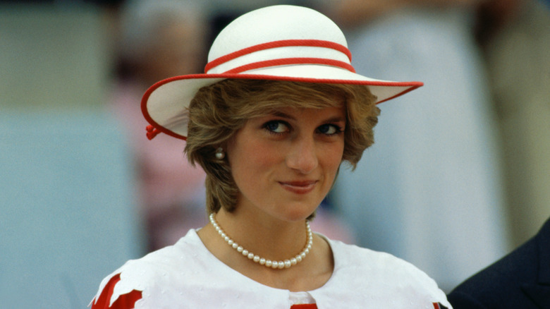 Princess Diana wearing a white and red striped hat