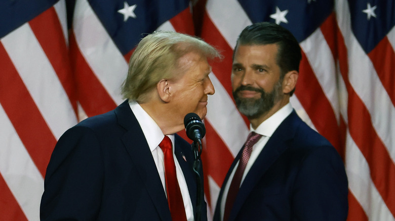 Donald Trump Jr. awkwardly smiling while his father looks at him