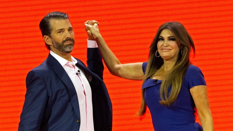 Donald Trump Jr. and Kimberly Guilfoyle awkwardly holding hands