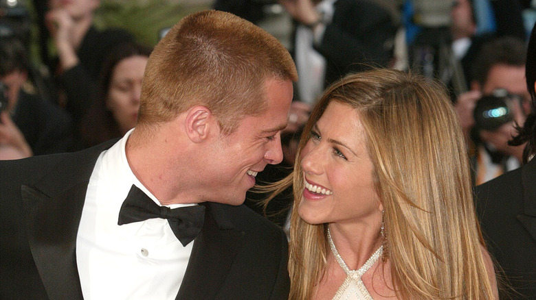 Jennifer Aniston and Brad Pitt smiling on the red carpet