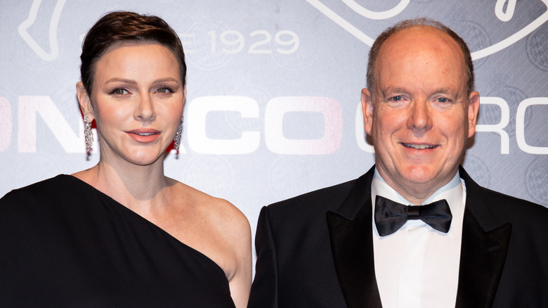 Princess Charlene and Prince Albert posing at a black tie affair