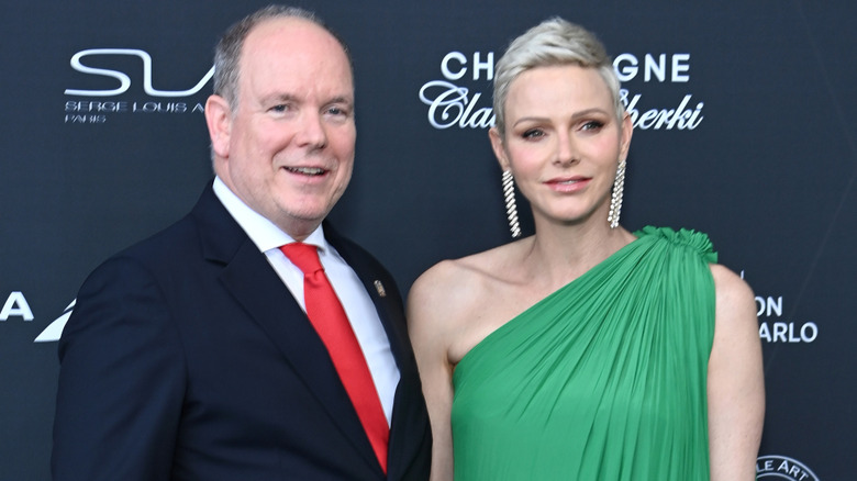 Prince Albert and Princess Charlene posing at an event