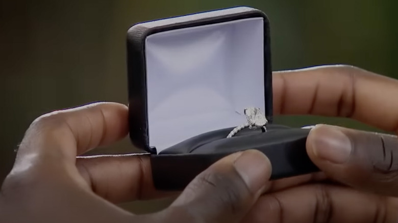 Hands hold engagement ring on The Bachelorette