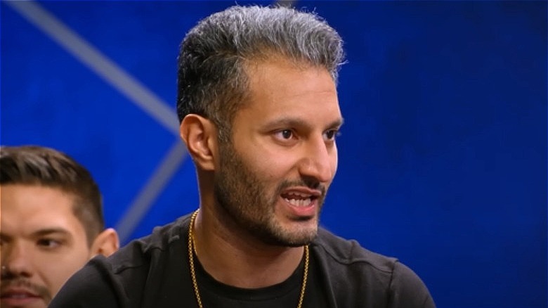 Abhishek "Shake" Chatterjee in front of blue backdrop