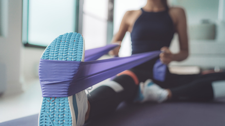 Woman exercising with resistance band