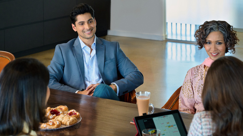 Rushi Kota and Rekha Sharma smiling and sitting