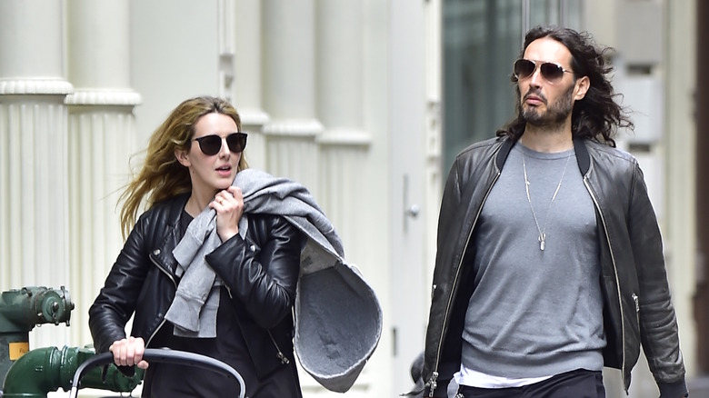 Laura Gallacher and Russell Brand walking around city