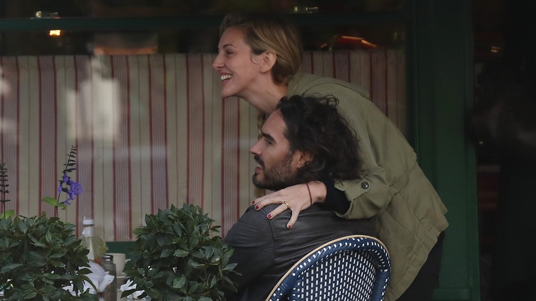 Russell Brand and Laura Gallacher at outdoor cafe