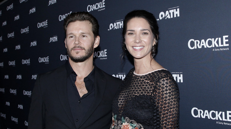 Ryan kwanten and Ashley Sisino posing for press