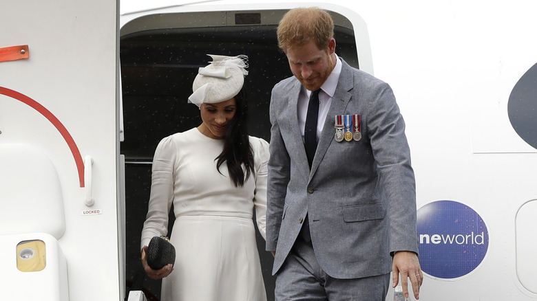 Meghan Markle and Prince Harry leaving an airplane