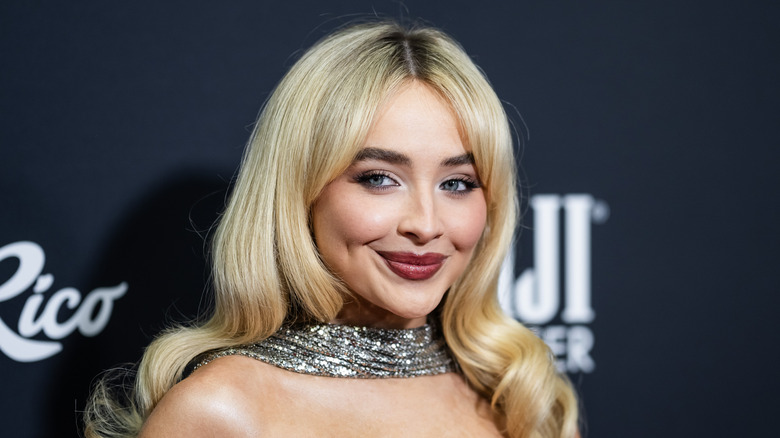 Sabrina Carpenter smirks at an event