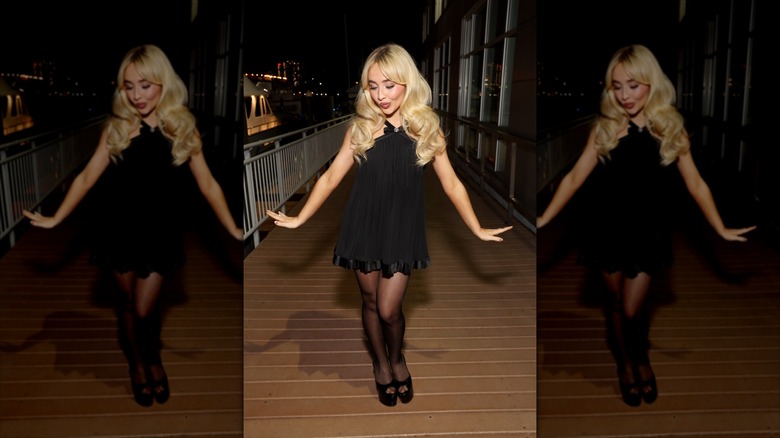 Sabrina Carpenter dances on a boardwalk