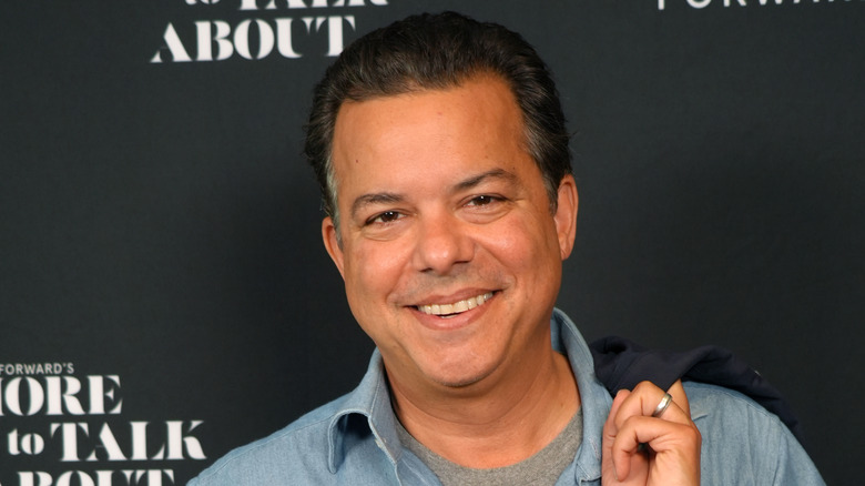 Former CNN anchor John Avlon smiling on a red carpet