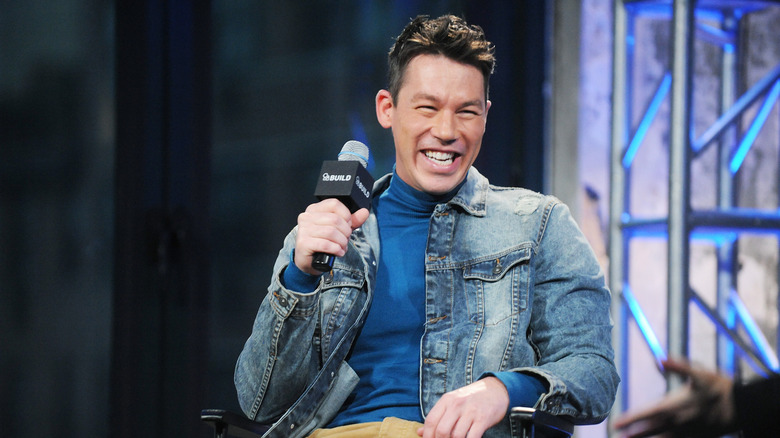 David Bromstad smiles while holding a microphone